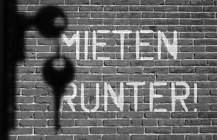 house wall with “lower the rent” slogan